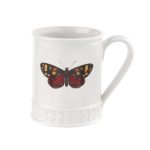 A white Portmeirion Botanic Garden Harmony tankard mug featuring a colourful butterfly on the front
